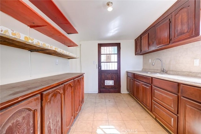 kitchen with light tile patterned floors, sink, and tasteful backsplash