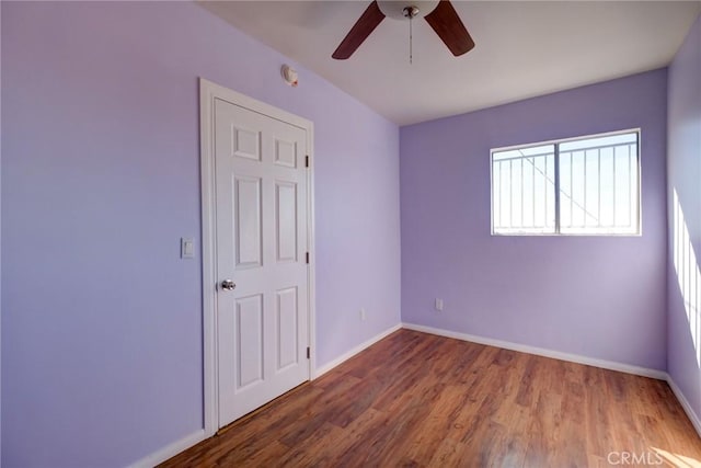 spare room featuring hardwood / wood-style flooring and ceiling fan