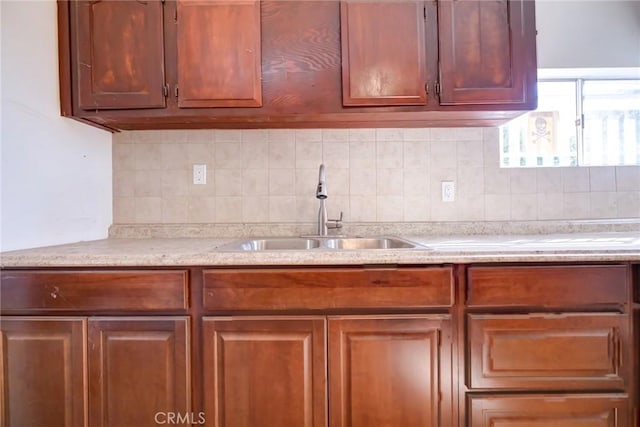 kitchen featuring tasteful backsplash and sink