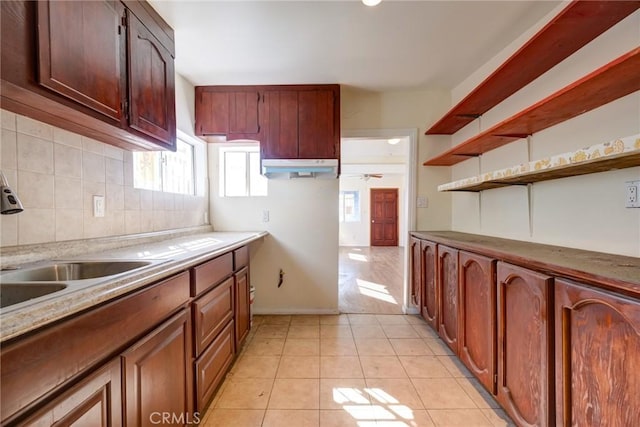 kitchen featuring light tile patterned floors, tasteful backsplash, ceiling fan, and sink