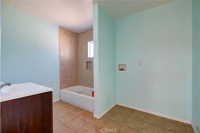 bathroom featuring tile patterned floors, vanity, and tiled shower / bath