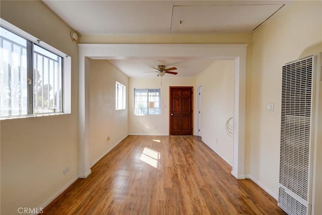 unfurnished room with ceiling fan and light wood-type flooring