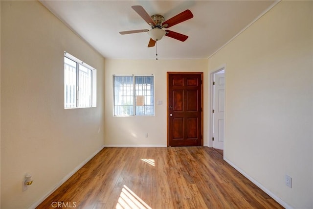 empty room with ceiling fan and light wood-type flooring