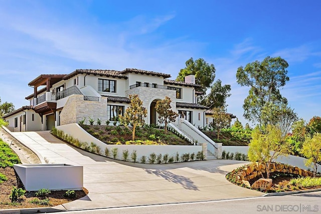 mediterranean / spanish-style home featuring a balcony