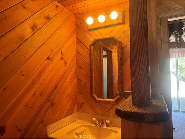 bathroom with wooden walls and sink