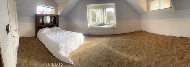 carpeted bedroom featuring lofted ceiling