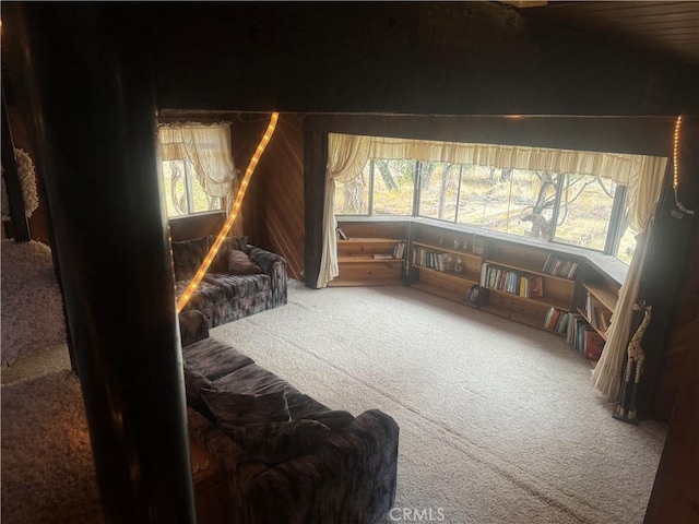 sitting room with carpet flooring, plenty of natural light, and lofted ceiling