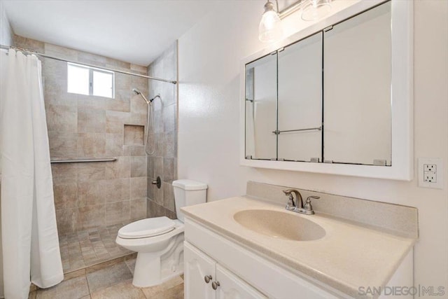 bathroom featuring tile patterned floors, vanity, toilet, and curtained shower