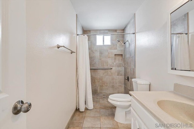 bathroom featuring walk in shower, tile patterned flooring, vanity, and toilet