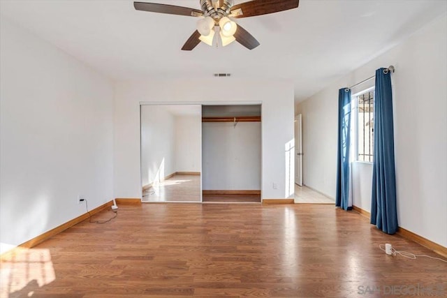 unfurnished bedroom with a closet, ceiling fan, and hardwood / wood-style floors