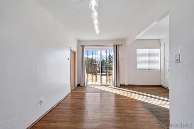 unfurnished room with hardwood / wood-style flooring