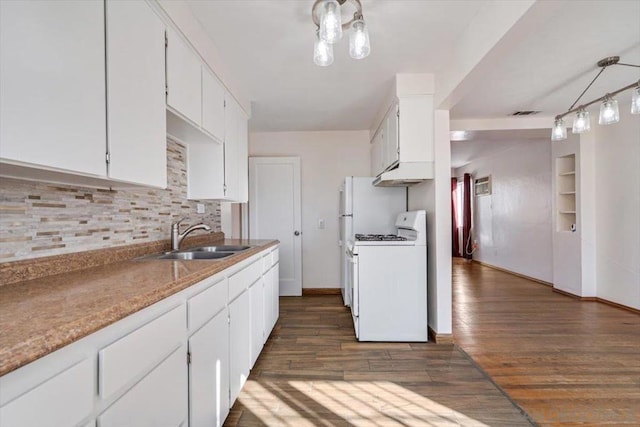 kitchen featuring dark hardwood / wood-style flooring, sink, pendant lighting, white cabinetry, and white gas stove