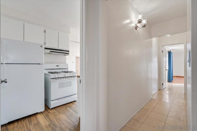 kitchen featuring white cabinets, ventilation hood, white appliances, and light hardwood / wood-style flooring