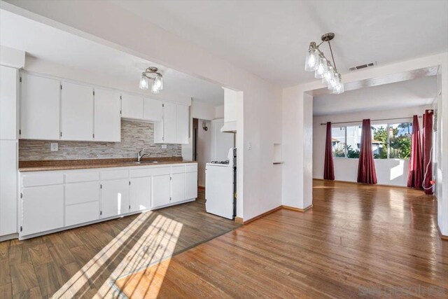 kitchen with dark hardwood / wood-style floors, pendant lighting, and white range