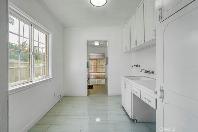 washroom featuring washer hookup, crown molding, and sink