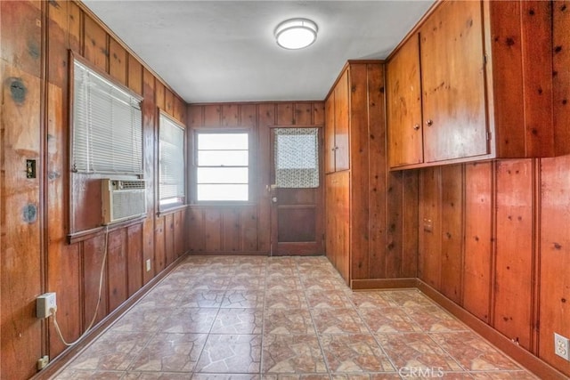 entryway featuring cooling unit and wooden walls