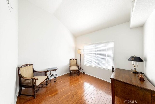 27551 Paseo Tamara, San Juan Capistrano, CA 92675 - sitting room featuring lofted ceiling, hardwood / wood-style flooring, and baseboards