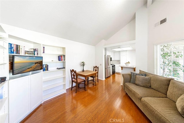 27551 Paseo Tamara, San Juan Capistrano, CA 92675 - living room featuring wood finished floors, built in shelves, and high vaulted ceiling
