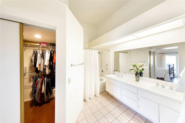 bathroom featuring tile patterned flooring, vanity, and shower / tub combo