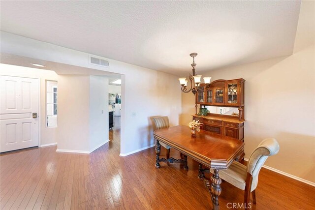 27551 Paseo Tamara, San Juan Capistrano, CA 92675 - dining room with a chandelier, baseboards, wood finished floors, and a textured ceiling