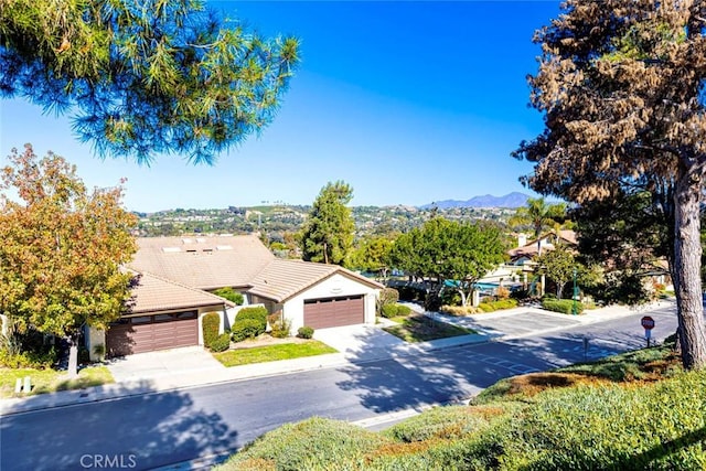 view of front of property with a mountain view and a garage