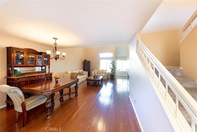 27551 Paseo Tamara, San Juan Capistrano, CA 92675 - dining area featuring dark wood finished floors, stairway, a chandelier, baseboards, and a textured ceiling