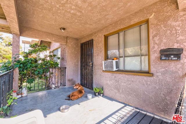 entrance to property featuring cooling unit