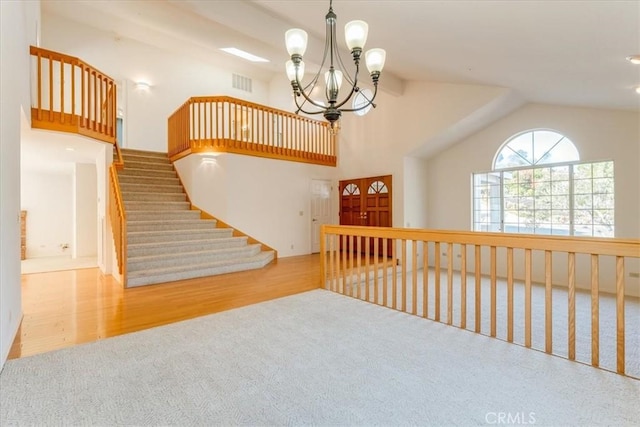 interior space featuring a chandelier, light hardwood / wood-style flooring, and lofted ceiling