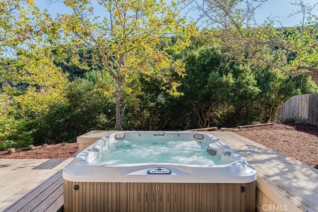 view of swimming pool with a wooden deck and a hot tub