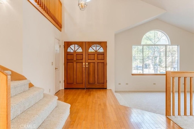 entrance foyer featuring lofted ceiling and light wood-type flooring