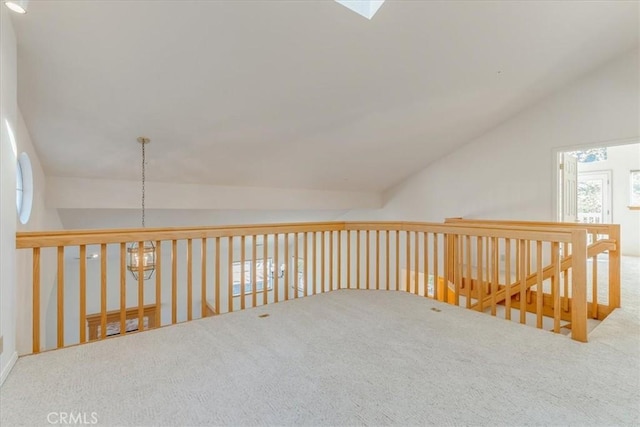 additional living space featuring vaulted ceiling with skylight and carpet