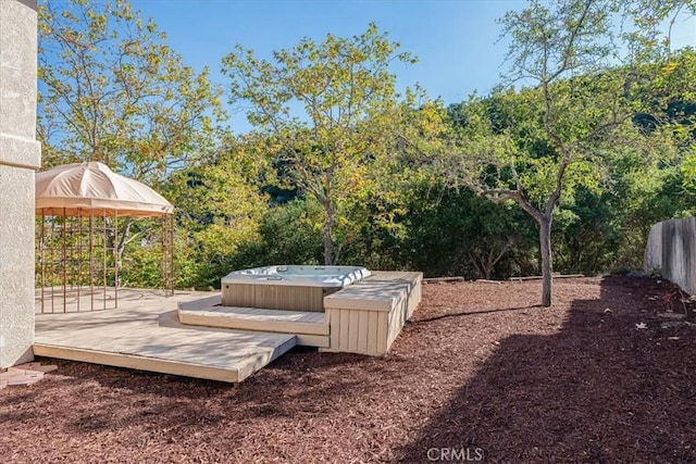 view of yard featuring a gazebo, a hot tub, and a wooden deck