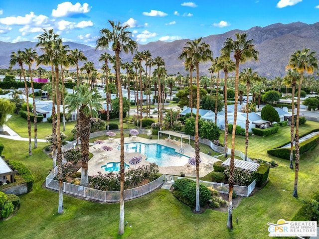 view of swimming pool with a mountain view