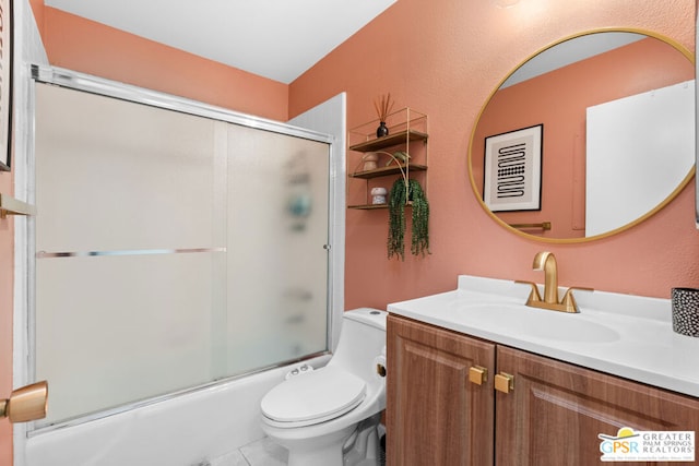 full bathroom featuring tile patterned flooring, vanity, toilet, and bath / shower combo with glass door