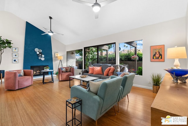 living room with high vaulted ceiling, light hardwood / wood-style flooring, and ceiling fan