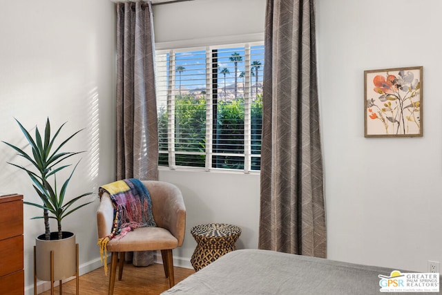 bedroom with hardwood / wood-style flooring and multiple windows