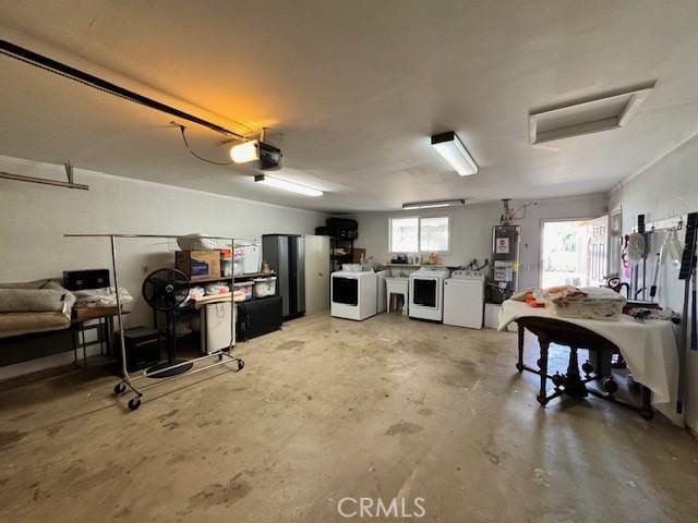 garage featuring a garage door opener, washer and clothes dryer, and water heater