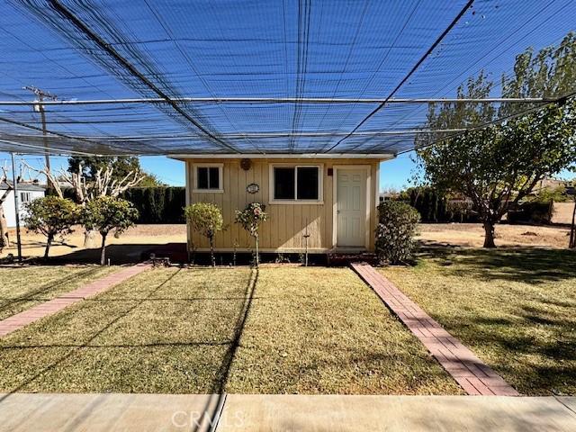 view of outbuilding with a lawn