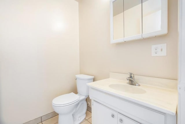 bathroom with vanity, tile patterned floors, and toilet