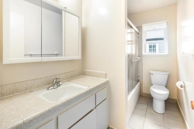 full bathroom featuring enclosed tub / shower combo, vanity, toilet, and tile patterned flooring