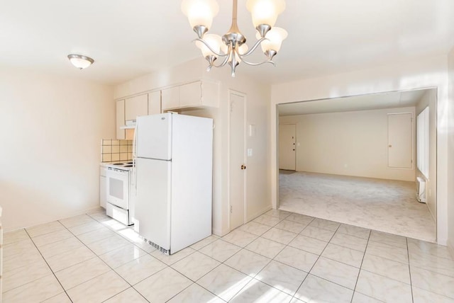 kitchen with pendant lighting, white appliances, white cabinetry, light carpet, and a chandelier