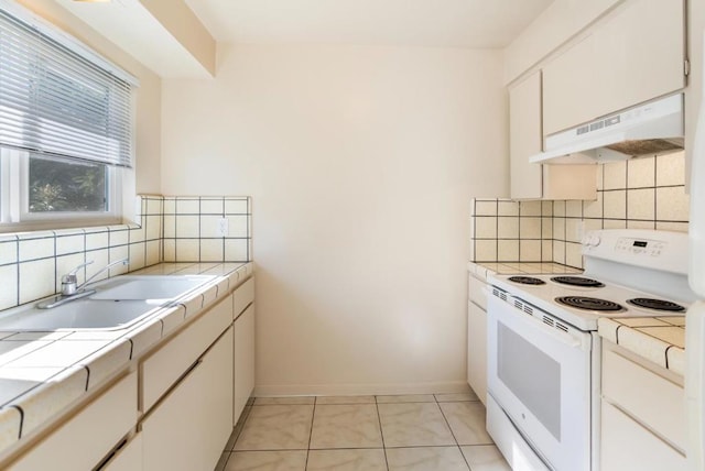 kitchen featuring tile countertops, sink, white cabinets, white electric range oven, and light tile patterned floors