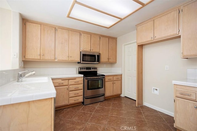 kitchen with sink, light brown cabinets, and appliances with stainless steel finishes