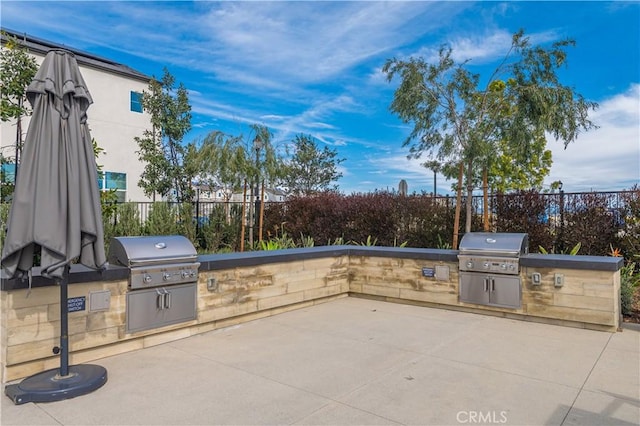 view of patio with an outdoor kitchen and area for grilling