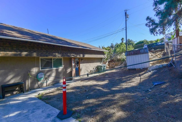 view of property exterior featuring a storage unit