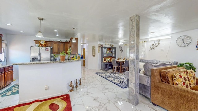 kitchen featuring decorative light fixtures and stainless steel refrigerator with ice dispenser