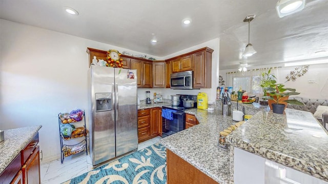 kitchen with hanging light fixtures, ceiling fan, kitchen peninsula, stainless steel appliances, and light stone countertops