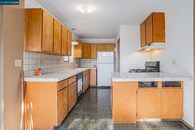 kitchen with black dishwasher, stove, white refrigerator, and tile countertops