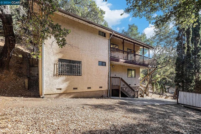 back of house with a balcony