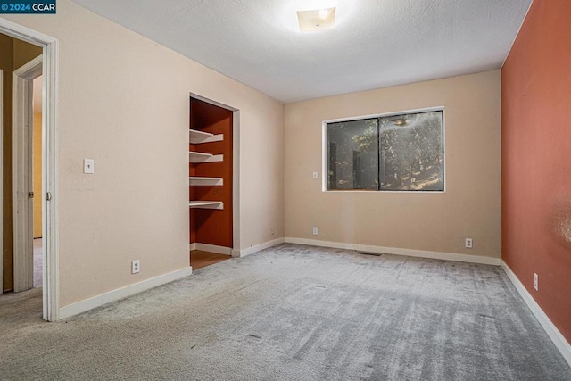 carpeted empty room with built in features